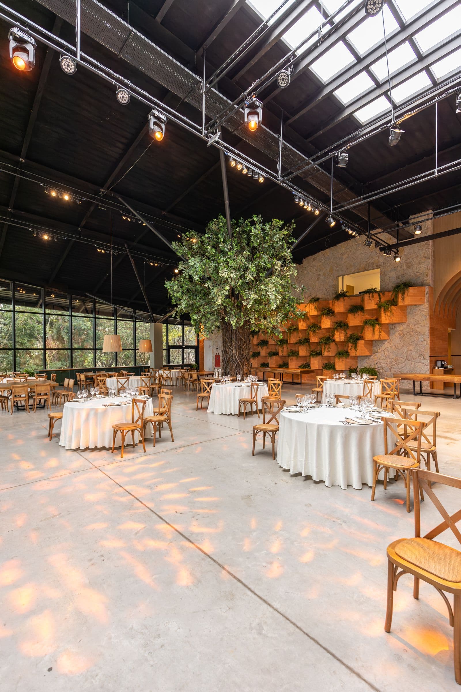 Private event space prepared with round tables, chairs, and professional overhead lighting